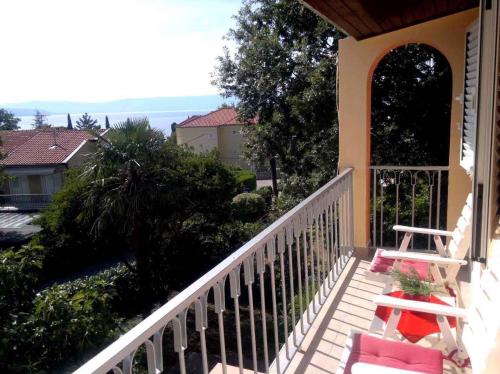a balcony of a house with two chairs at Apartment in Njivice/Insel Krk 13324 in Njivice