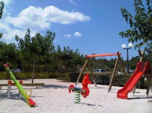 a playground with slides and play equipment in a park at Apartment in Klimno/Insel Krk 12479 in Klimno