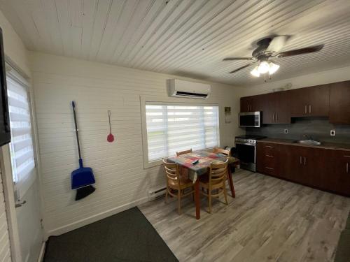 a kitchen with a table and chairs in a room at Newly Renovated Confederation Bridge View Cottages in Borden