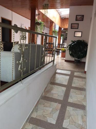 a staircase in a house with a tile floor at Hermosa Casa en el centro de Santa Rosa de Cabal, sobre vía principal a 3 cuadras de la Plaza in Santa Rosa de Cabal
