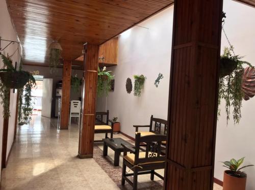 a living room with a bunch of chairs in it at Hermosa Casa en el centro de Santa Rosa de Cabal, sobre vía principal a 3 cuadras de la Plaza in Santa Rosa de Cabal
