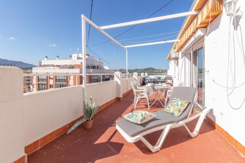 a balcony with chairs and a table on a building at Pondarosa Penthouse 55 - Costa CarpeDiem in Calpe