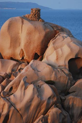 a rock formation with a structure on top of it at Hotel Moderno in Santa Teresa Gallura