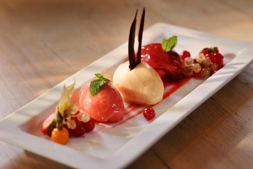 a plate of food with fruit on a table at Romantik Hotel Knippschild in Rüthen