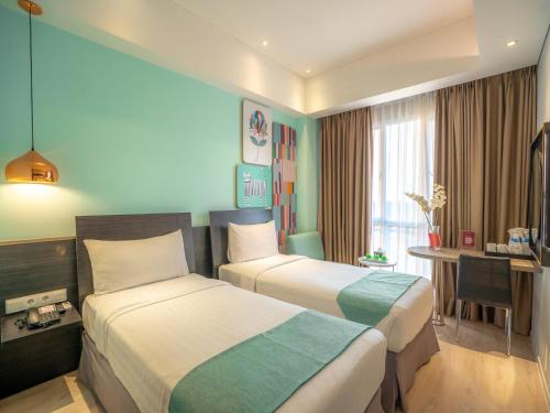 Tempat tidur dalam kamar di Brits Hotel Puri Indah