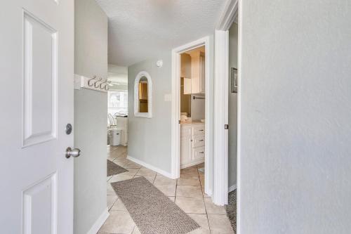 a hallway with a white door and a kitchen at Seascape 2309 Condo in Galveston