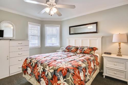a bedroom with a bed and a ceiling fan at Seascape 2309 Condo in Galveston