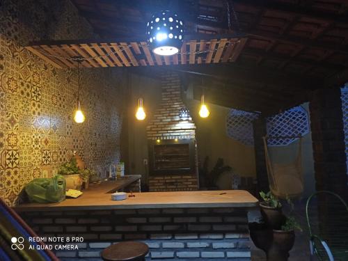 a bar in a restaurant with lights on the wall at Recanto Dos Lençóis in Barreirinhas