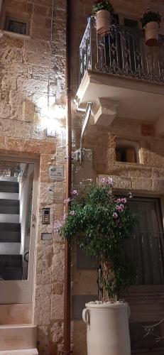 a large pot with a plant in front of a building at Casetta del Pescatore in Polignano a Mare