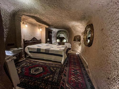 a bedroom with a bed and a rug at Sofa Hotel in Avanos