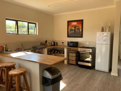 a kitchen with a counter and a white refrigerator at Troutbagger Farm in Nottingham Road