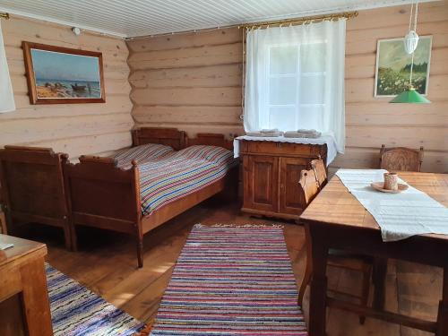 - une chambre avec 2 lits, une table et une fenêtre dans l'établissement Ligedama Wabatalu, à Koljaku