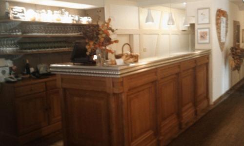 a kitchen with a large wooden counter top at Auberge et Hostellerie Paysanne in Lutter