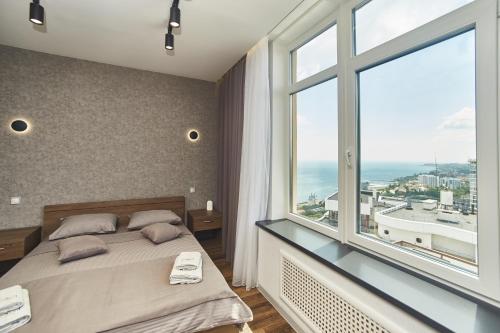 a bedroom with a bed and a large window at Board apart hotel in Odesa