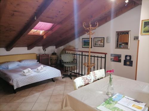 a bedroom with a bed and a table and chairs at La Calletta in Rovinj