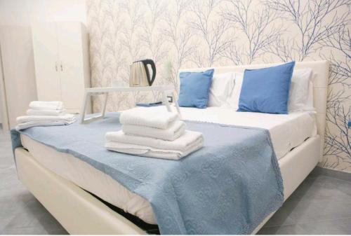 a bedroom with a bed with towels on it at Brighter's Room in Naples