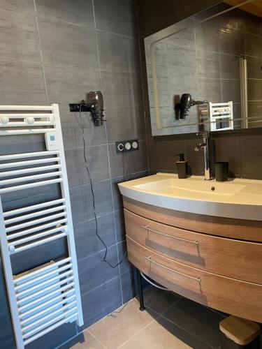 une salle de bain avec un lavabo et un miroir dans l'établissement Petite maison en pleine campagne, à Labastide-Gabausse