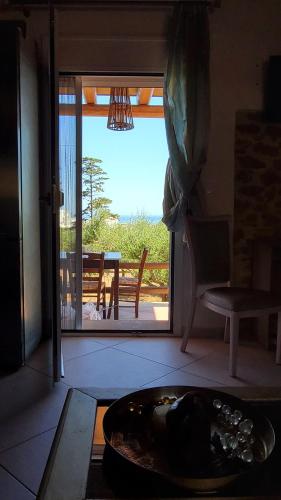 a living room with a door open to a patio at Momentum Θ in Maleme
