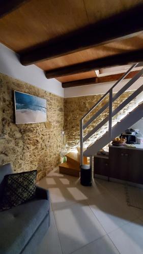a living room with a couch and a staircase at Momentum Θ in Maleme