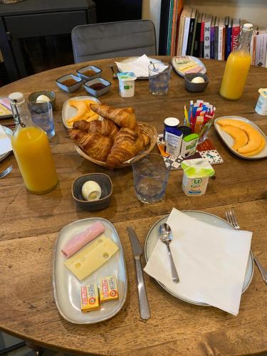une table recouverte d'assiettes de nourriture et de jus d'orange dans l'établissement La maison Gerval, à Bédoin
