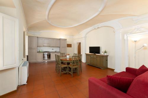 a living room with a red couch and a table at Era Rental Apartments in Florence