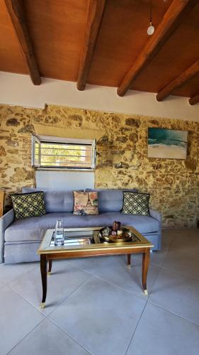 a living room with a blue couch and a table at Momentum Θ in Maleme