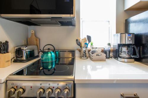 a kitchen with a stove with a tea pot on it at 09 Lodge Near Downtown Hood River in Hood River