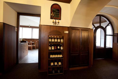 a room with a shelf of wine bottles at Hotel U Jiřího in Humpolec