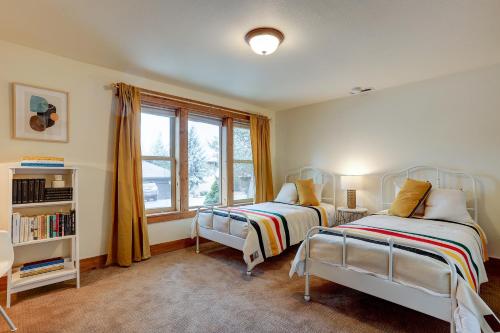 a bedroom with two beds and a window at The Bend House home in Bend