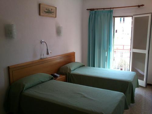 Postel nebo postele na pokoji v ubytování Hotel Bari