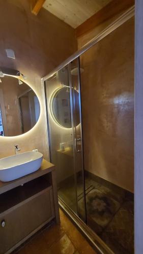a bathroom with a sink and a glass shower at Momentum Θ in Maleme