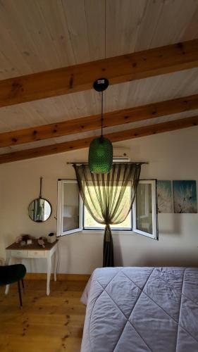 a bedroom with a bed and a window and a table at Momentum Θ in Maleme