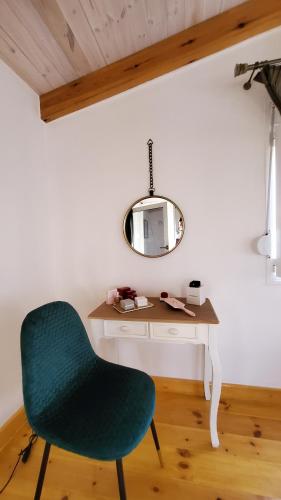 a green chair sitting next to a desk with a mirror at Momentum Θ in Maleme