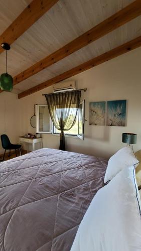 a bedroom with a large bed with a window at Momentum Θ in Maleme