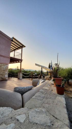 a group of couches sitting on a patio at Momentum Θ in Maleme