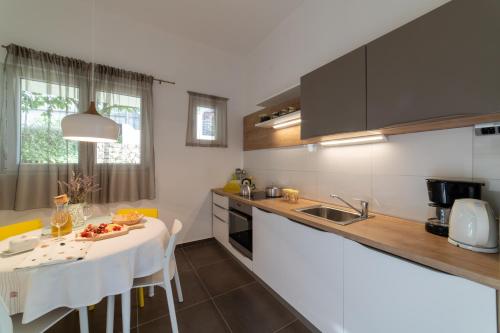 a kitchen with a table and a counter top at Apartment One in Okrug Donji