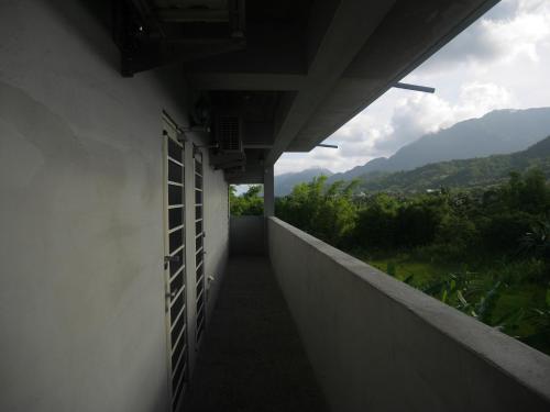 a hallway of a building with a view of mountains at 春夏秋冬海景民宿Ocean View Motel in Chenggong