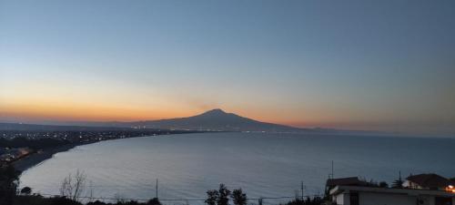 a view of a mountain in the ocean at sunset at Piccolo Podere in Melilli
