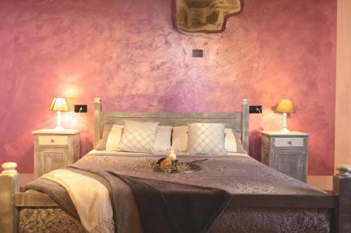 a bedroom with a bed with two lamps on two tables at Casa di campagna in Spoleto