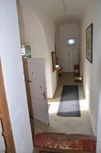 a hallway with a white door and a rug at Schloss Greillenstein in Wutzendorf