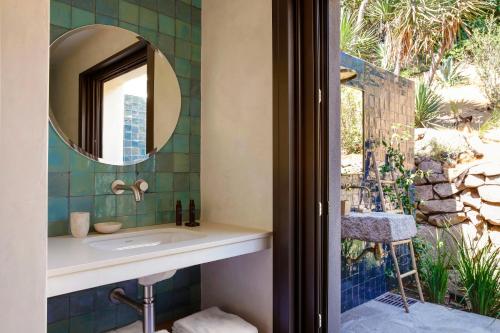 a bathroom with a sink and a mirror at Domaine Santa Giulia Palace in Porto-Vecchio