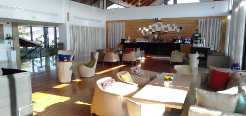a lobby with couches and tables and a bar at Bahia Golf Beach Bouznika appart in Bouznika