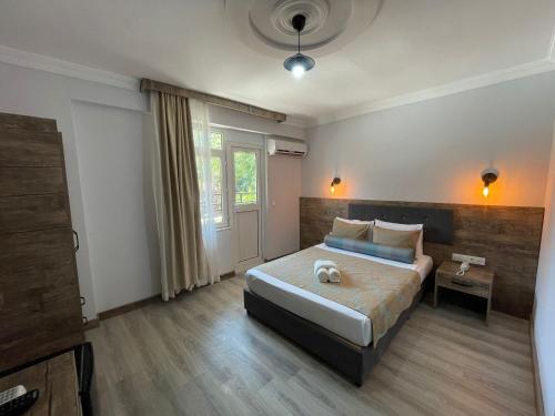 a bedroom with a large bed and a window at Seven City Hotel in Antalya