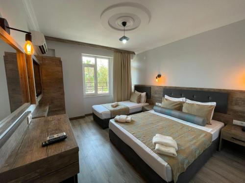 a bedroom with a large bed and a couch and a bed and a couch at Seven City Hotel in Antalya