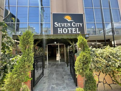 a hotel entrance with a sign that reads seven city hotel at Seven City Hotel in Antalya