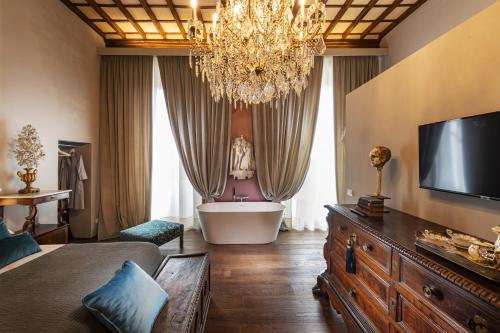 a living room with a chandelier and a bath tub at Casa Botticelli in Florence
