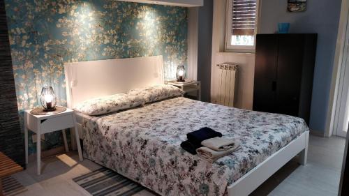 a bedroom with a bed and two night stands at Suite time Van Gogh in Catania