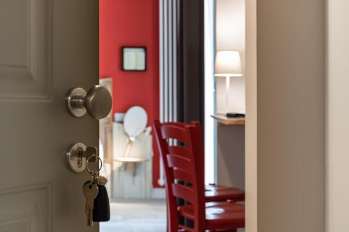 a red chair in a room with a red wall at Bed and Breakfast Bric & Brac in Grottammare