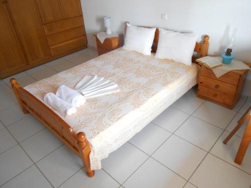 a bedroom with a bed with white sheets and pillows at Chrysolithos Kerami Apartments in Khalkíon