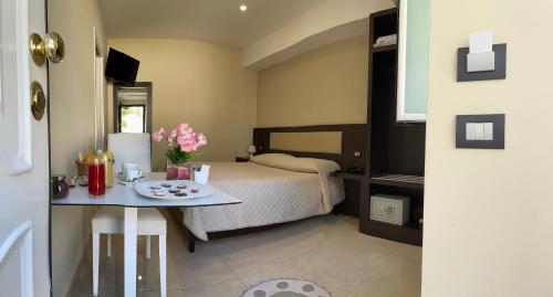 a bedroom with a bed and a table with flowers on it at Grand Hotel Royal in Pompei